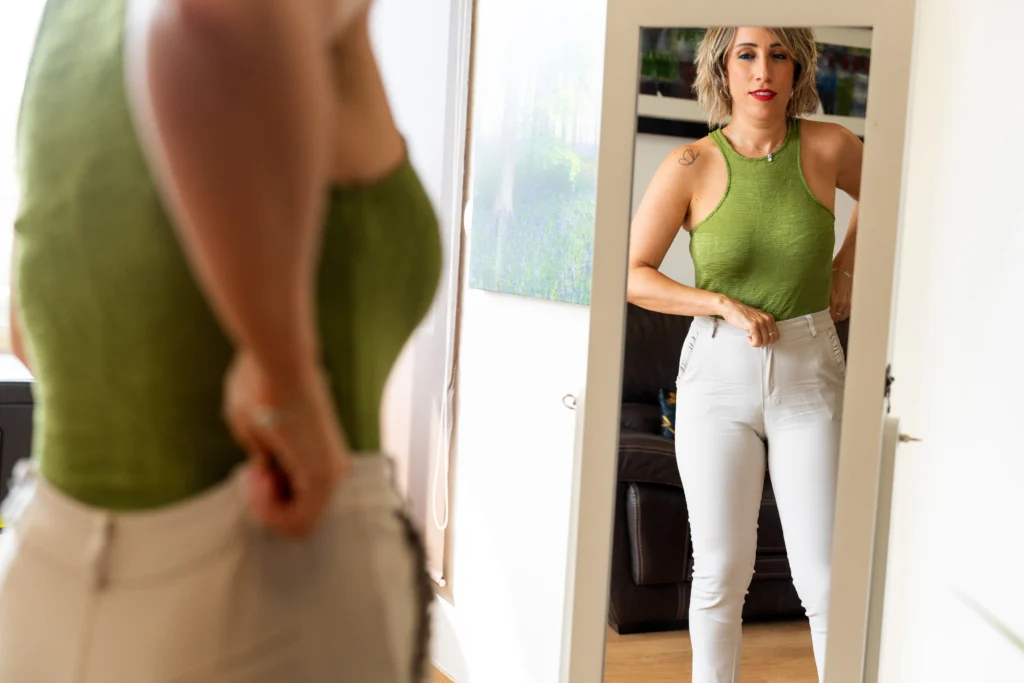 woman fitting into a new pair of jeans after loosing weight with medical weight loss from doctor slim med spa